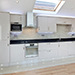 Sophisticated kitchen with built in fridge-freezer and microwave. Light, reflective floor mirrors illumination from skylight.